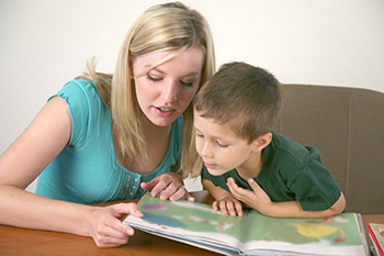 mom with son reading picture book