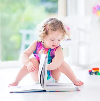 Toddler Girl Reading Book